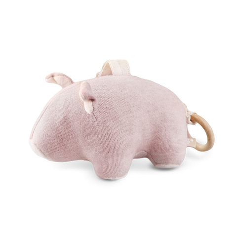 A pink plush hippopotamus toy with a wooden teething ring attached sits on a white background.